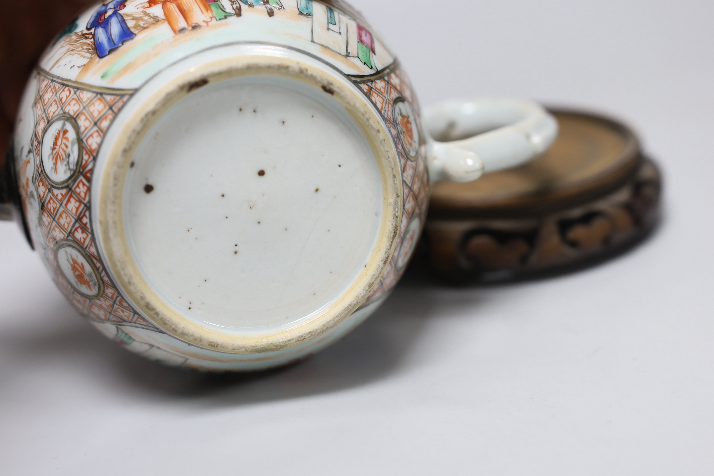 An 18th century Chinese export famille rose teapot with later silver spout and cover, on hardwood stand